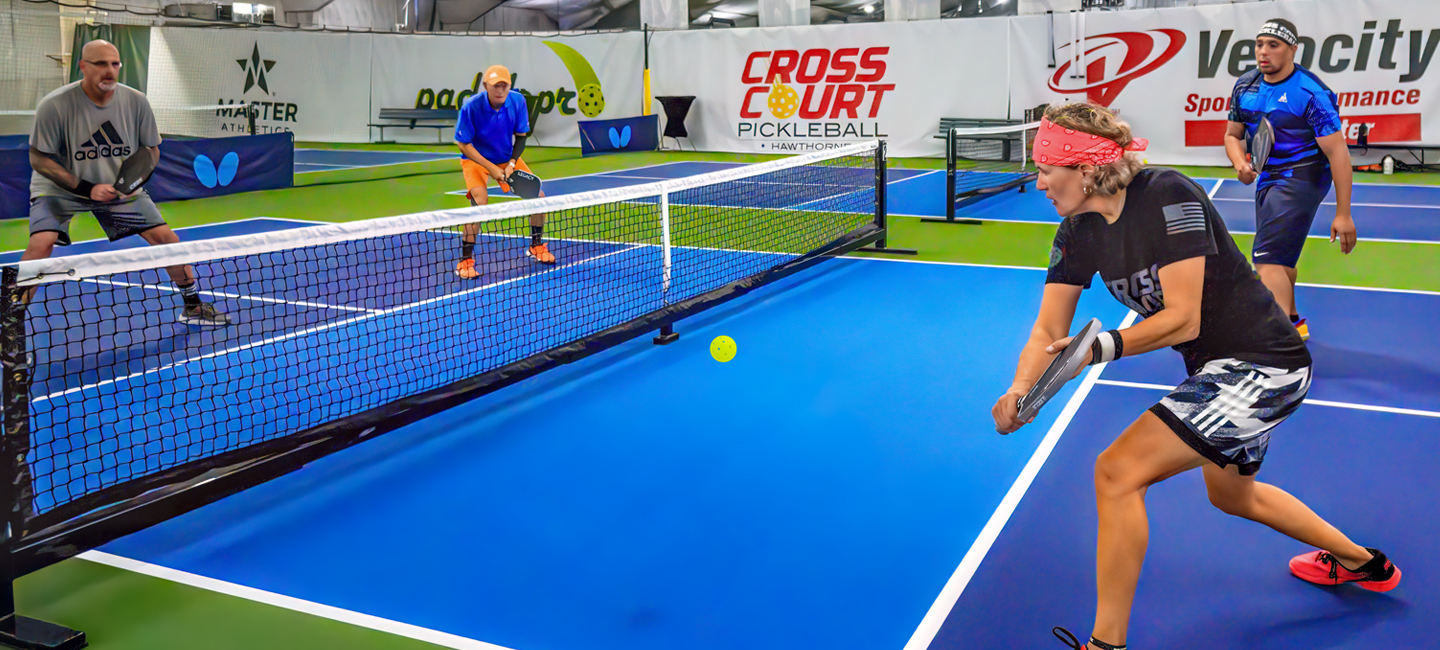 Four people playing pickleball.