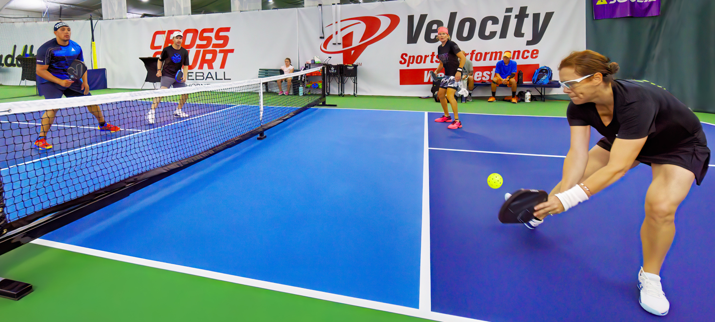 Four people playing pickleball