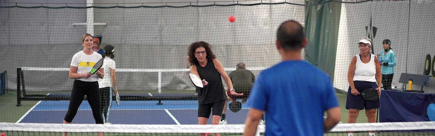 Photo of Pickleball players on a court